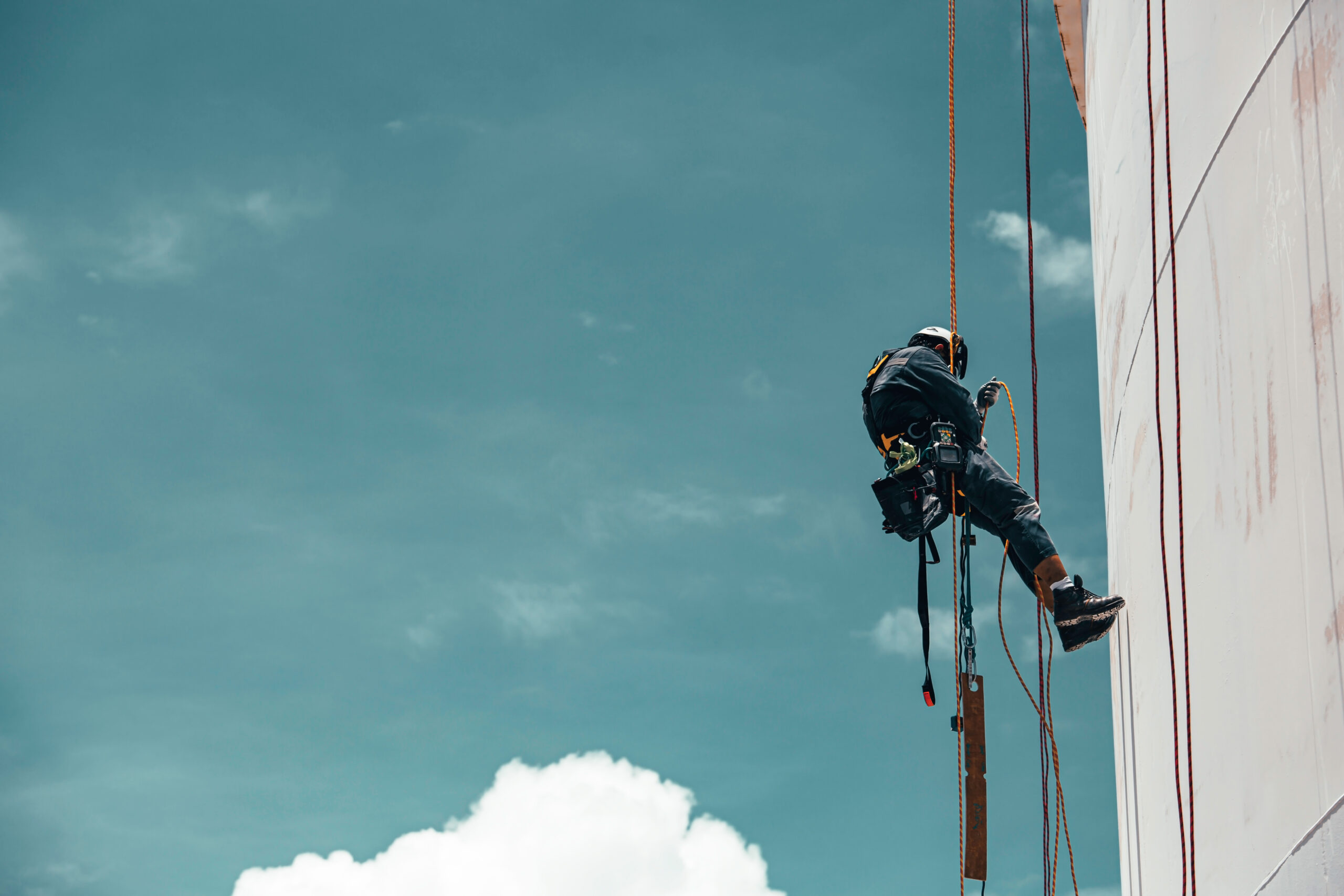 Male worker down height tank roof rope access safety inspection