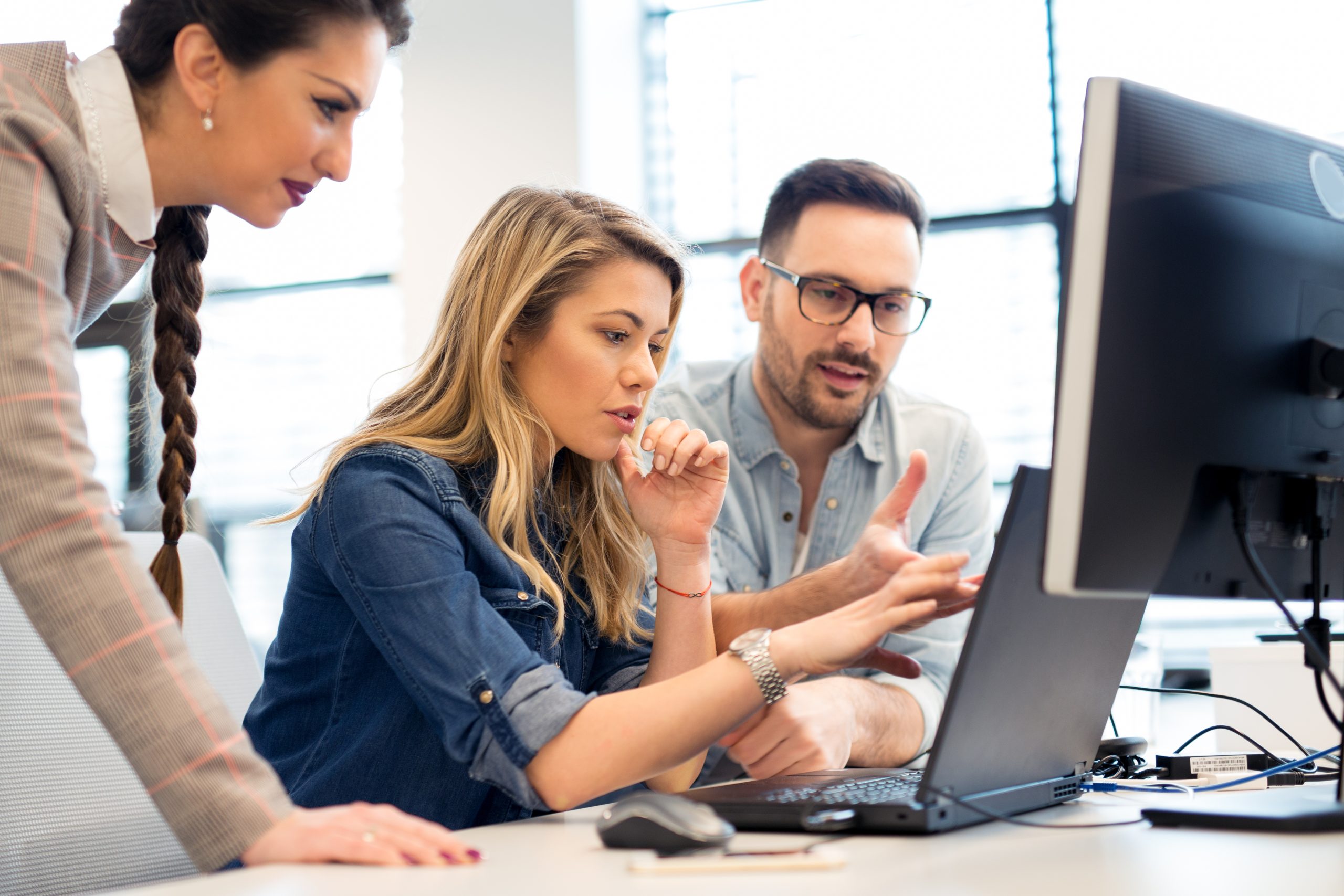 Group of business people and software developers working as a te